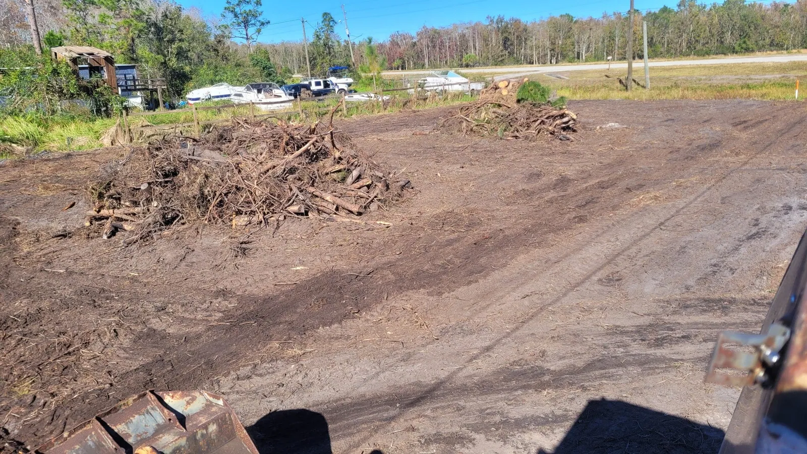 Cleared lot with brush piles after land clearing near St. Cloud, FL